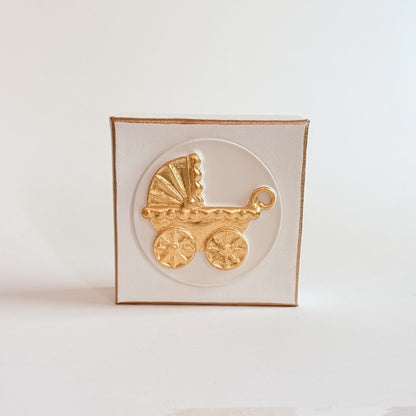 Gold baby carriage on a white square canvas with a white background and gold trim