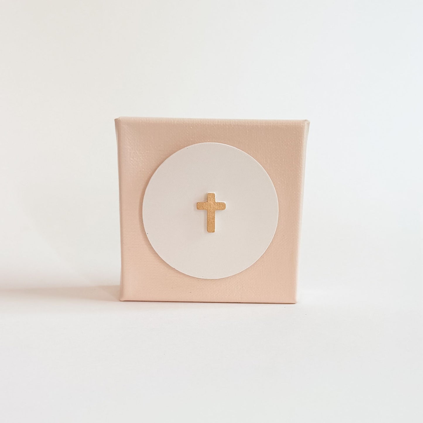 Pink box with a gold cross on a white background