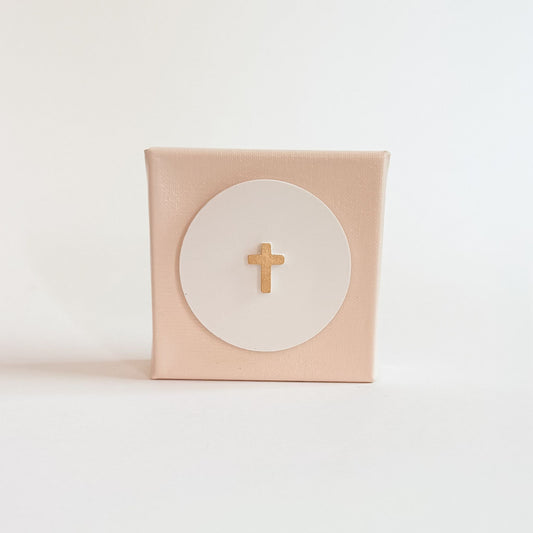 Pink box with a gold cross on a white background