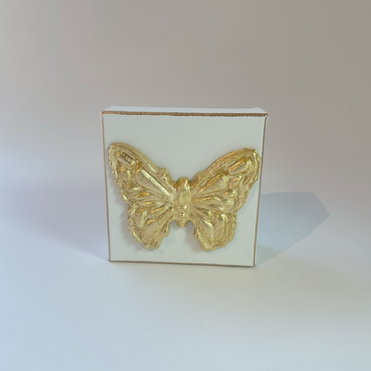 A 4x4 inch canvas with a handcrafted gold butterfly intaglio, displayed against a neutral background.