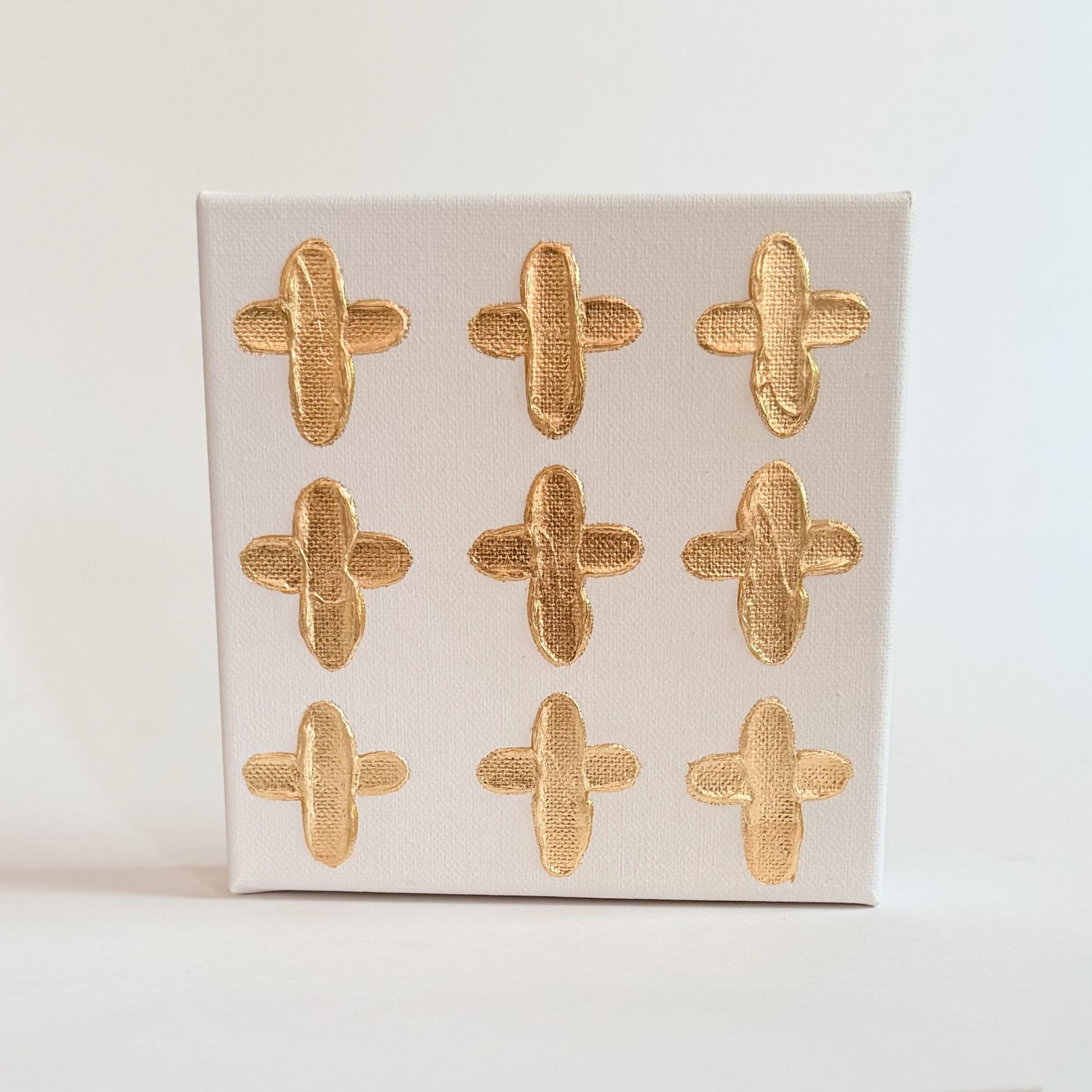 9 gold handpainted hearts on a 6 inch byt 6 inch canvas 